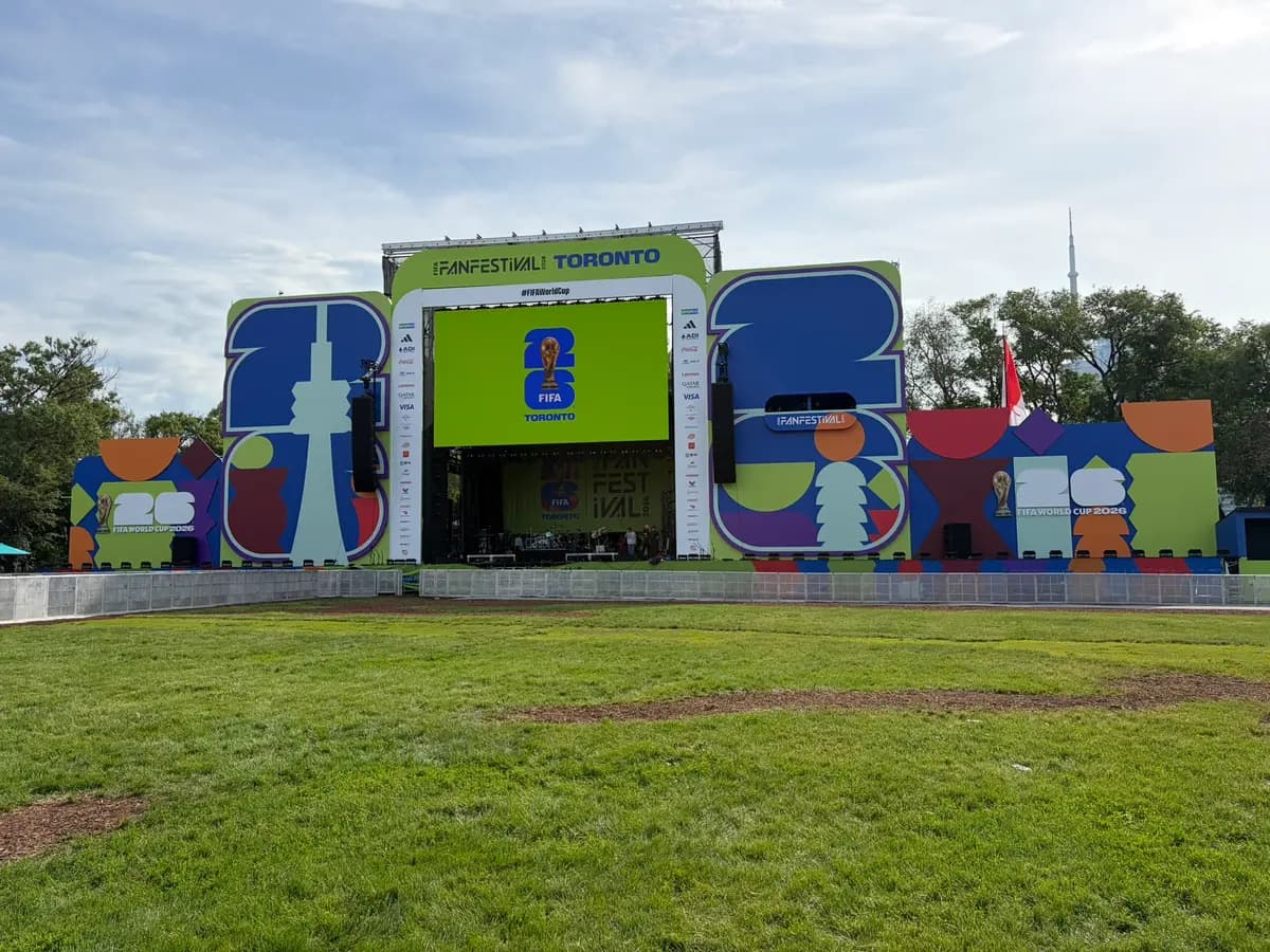 Head-on view of the completed FIFA Fan Festival Toronto main stage with LED screen, sponsor towers and barricade line