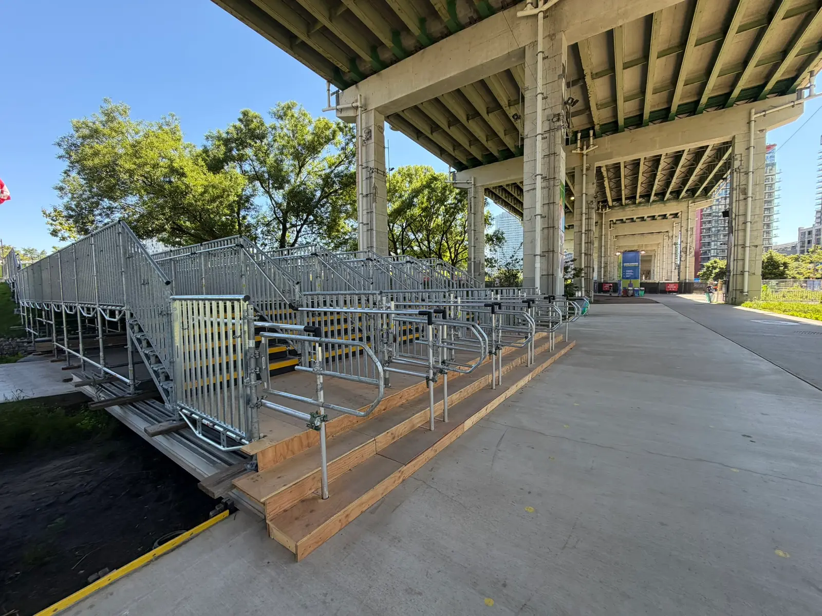 Temporary scaffold stair and ramp system with high-visibility safety treads under the Gardiner Expressway